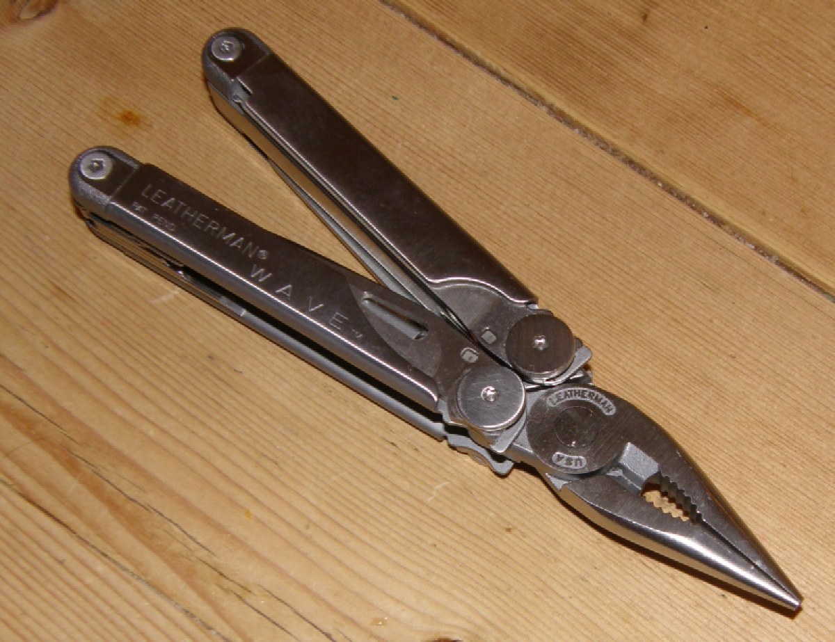 Leatherman Wave multi-tool (original Wave pictured; the Wave+ adds replaceable wire cutters) partially opened, showing stainless handles and plier head