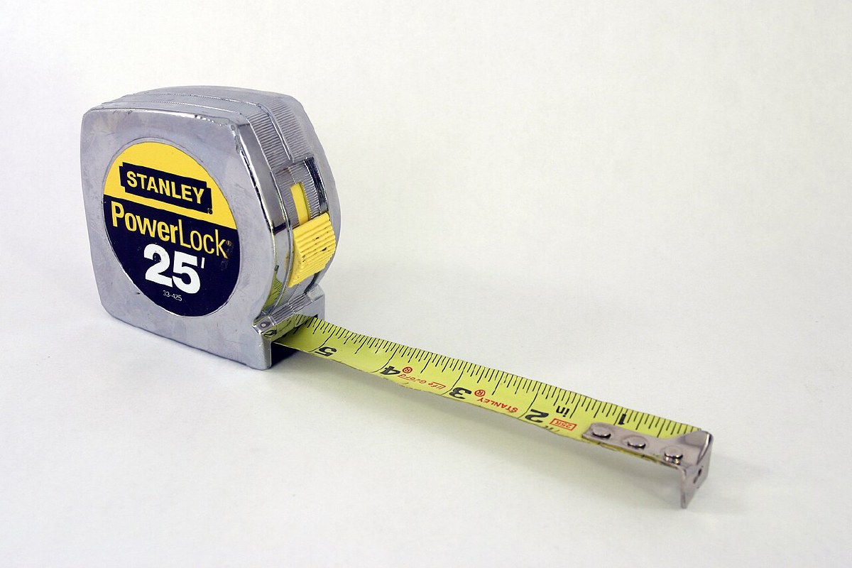 Stanley PowerLock 25-foot tape measure, model 33-425, with chrome case and yellow blade extended showing the Tru-Zero end hook
