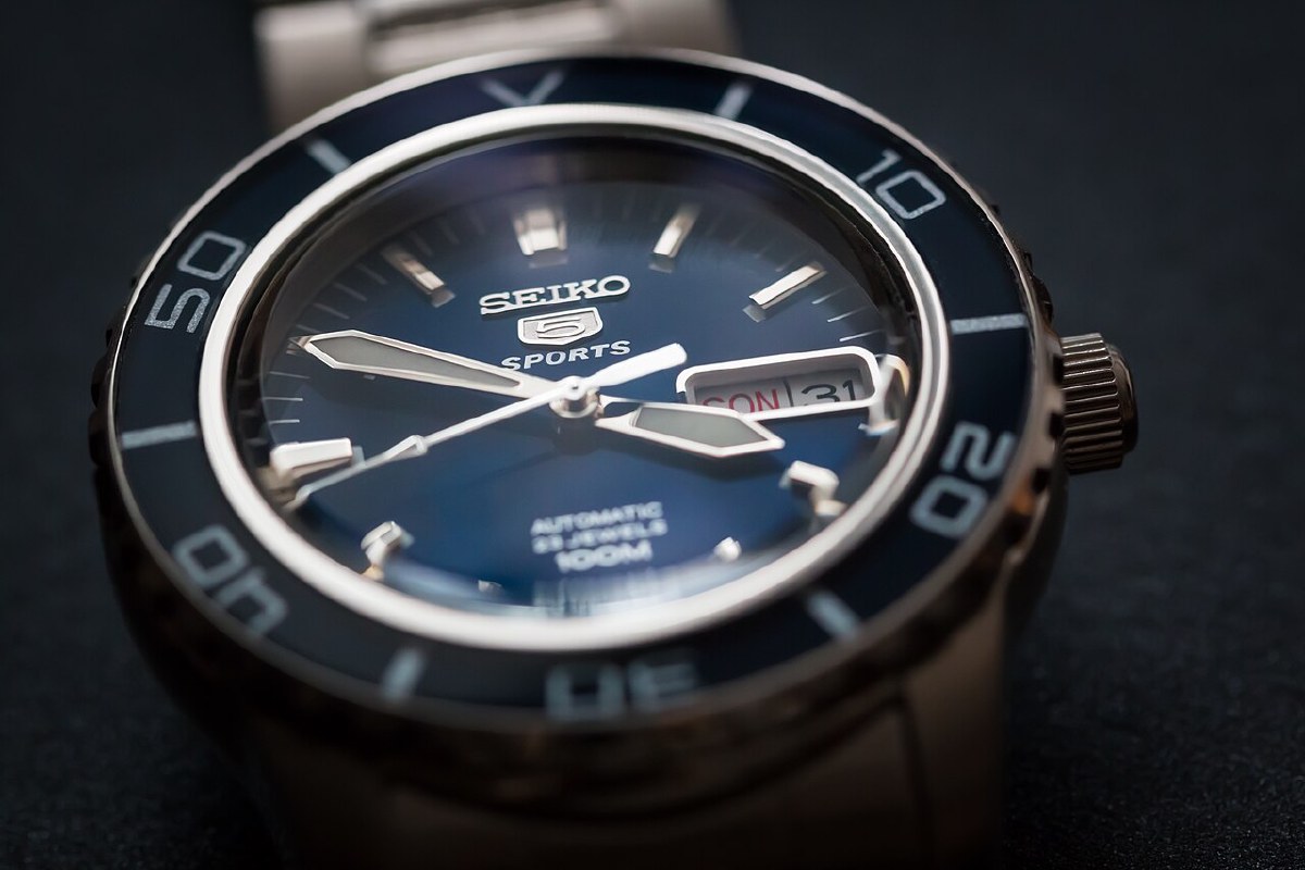 Macro photograph of a Seiko 5 Sports automatic dial — pictured is the SNZH53, an earlier generation of the same Seiko 5 Sports line as the SRPD
